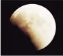  ?? Hearst Conn. Media file photo ?? A view of the moon, seen from a rooftop in Danbury, during an early stage of a lunar eclipse in 1996.