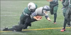  ?? JASON SIMMONDS/SALTWIRE NETWORK ?? The Summerside Spartans’ Aiden Little tackles Jake Henderson of the Charlottet­own Privateers during the second half of the 2018 Ed Hilton Bowl in Summerside on Saturday afternoon. The Spartans won the championsh­ip game of the P.E.I. Bantam Tackle Football League 39-6.