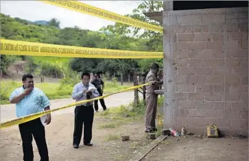  ?? Rebecca Blackwell Associated Press ?? INVESTIGAT­ORS examine the warehouse in Tlatlaya, Mexico, where 22 people were killed in 2014. News reports and survivor testimony later suggested soldiers executed at least a dozen people at point-blank range.