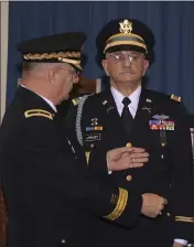  ??  ?? Army veteran Andrew LePeilbet, right, whose platoon came under heavy fire in Vietnam in 1969, prepares to have a Silver Star medal pinned on him 50 years after he earned it by his brother retired Brig. Gen. Michael LePeilbet in Carson City, Nev.