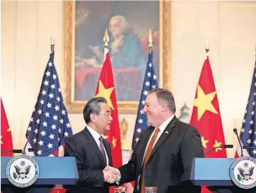  ?? [AP PHOTO] ?? Secretary of State Mike Pompeo and Chinese State Councilor and Foreign Minister Wang Yi shake hands following a news conference Wednesday at the State Department in Washington.