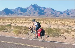  ??  ?? Top left: Sam makes a quick stop in Texas; right: his route across America, and above: cycling through the Mojave desert in California.