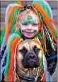  ??  ?? Grace Wilson, 7, waits for the 2017 New Haven St. Patrick’s Day parade with her dog, Macie.