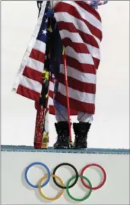  ?? GERO BRELOER - THE ASSOCIATED PRESS ?? FILE - In this Feb. 21, 2014 file photo women’s slalom gold medal winner Mikaela Shiffrin of the United States poses for photograph­ers with the U.S. flag at the Sochi 2014 Winter Olympics in Krasnaya Polyana, Russia.