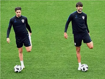  ?? — AFP ?? Stretch: Croatia defenders Sime Vrsaljko (left) and Vedran Corluka warming up during a training session at the Roschino Arena on Sunday.