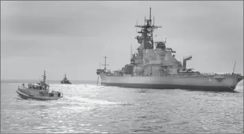  ?? Don Bartletti Los Angeles Times ?? A COAST GUARD VESSEL approaches the battleship Iowa as it arrives from the San Francisco Bay. After the hull is cleaned, the Iowa will be moved to its permanent home as a museum on the San Pedro waterfront.