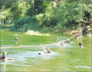  ??  ?? SURVIVAL OF THE FITTEST . . . Soldiers cross a river during the Inter-Formations Recce Platoon Competitio­n at Wafa Wafa Training Camp in Kariba last week. The soldiers were tested in a number of skills including bush craft, tracking skills, individual...