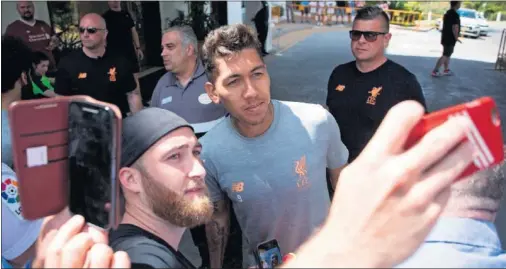  ??  ?? EXPECTACIÓ­N. Firmino se fotografía con un aficionado del Liverpool en la entrada del hotel Westin La Quinta Golf Resort de Marbella.