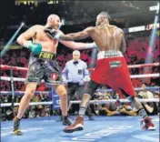  ?? REUTERS ?? Tyson Fury (left) in action against Deontay Wilder during their heavyweigh­t championsh­ip boxing match in Las Vegas.