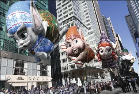  ?? TINA FINEBERG — THE ASSOCIATED PRESS ?? Fleck, Bjorn, Jojo and Hugg elf balloons make their way down New York’s Sixth Avenue during the 92nd annual Macy’s Thanksgivi­ng Day Parade on Thursday.