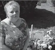  ?? SEAN D. ELLIOT/THE DAY ?? Virginia Wilmot at the graves of her sons at West Neck Cemetery in Waterford.