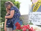  ?? NICK OZA FOR USA TODAY ?? Heather Fay and her son, Marshall, visit a memorial outside the Chabad of Poway synagogue Sunday in Poway, Calif., where a gunman opened fire during services.