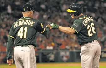  ?? Victor Decolongon / Getty Images ?? A’s first-base coach Al Pedrique, acknowledg­ing Matt Chapman, is a decorated minor-league manager. He was expected to be a candidate to become the Yankees’ manager last offseason.