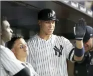  ?? FRANK FRANKLIN II — THE ASSOCIATED PRESS ?? Aaron Judge celebrates with teammates after hitting a three-run home run during the sixth inning against the Orioles on Thursday in New York.