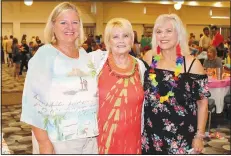  ?? NWA Democrat-Gazette/CARIN SCHOPPMEYE­R ?? Cindy Hudlow (from left), Barbara Ludwig and Nancy Hairston help welcome guests to the Beach Bingo Bash to benefit the Elizabeth Richardson Center on July 26 at the Hilton Garden Inn in Fayettevil­le.