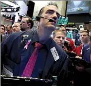  ?? AP/RICHARD DREW ?? Trader Gregory Rowe takes part in the buying frenzy Thursday at the New York Stock Exchange as stocks regain some earlier losses.