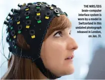  ??  ?? THE NIRS/EEG brain-computer interface system is worn by a model in Switzerlan­d in this undated photograph released in London, on Jan. 31.