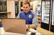  ?? JEFF BAENEN / ASSOCIATED PRESS ?? Tony Danna, vice president of internatio­nal developmen­t, works on his laptop at Three Square Market headquarte­rs in River Falls, Wis.