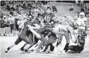  ??  ?? Lamar Brewster of Atlantic High School is tackled in the third quarter against Park Vista.