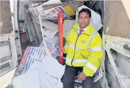  ??  ?? > Councillor Majid Mahmood with the van full of fly-posters taken down during the crackdown