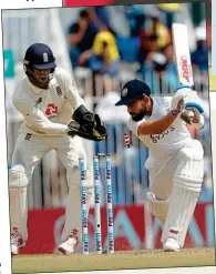  ??  ?? CAN’T BELIEVE IT: Kohli is stunned by Moeen’s magic and takes his time to trudge off