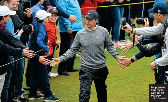  ?? GETTY IMAGES ?? Mr popular: fans try in vain to lift McIlroy