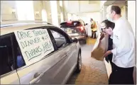  ?? Tyler Sizemore / Hearst Connecticu­t Media ?? Executive Chef Huib Kooij and Director of Revenue Management Laura McLoughlin deliver a meal.