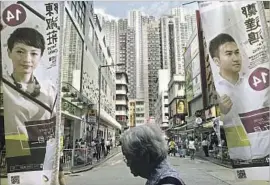  ?? Vincent Yu Associated Press ?? CAMPAIGN BANNERS for pro-democracy candidates Tanya Chan, left, and Cheng Tat-hung of the Civic Party hang on a street in Hong Kong.