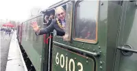  ??  ?? ●● Rossendale Mayor Colin Crawforth on the footplate of the Flying Scotsman during the loco’s visit to Rawtenstal­l Station, East Lancashire Railway