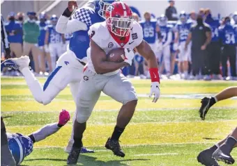  ?? PHOTO BY MARK CORNELISON ?? Georgia redshirt sophomore running back Zamir White had 26 carries for 136 yards during last Saturday’s 14-3 win at Kentucky. The Bulldogs visit Jacksonvil­le, Florida, this week to take on the Gators.