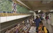  ?? RICHARD DREW — ASSOCIATED PRESS ?? The mosaic tile design meant to represent Times Square’s status as the “Crossroads of the World” is part of a subway station’s decorative border in New York Friday. Transit officials have decided to alter subway tiles that have a design that’s been...