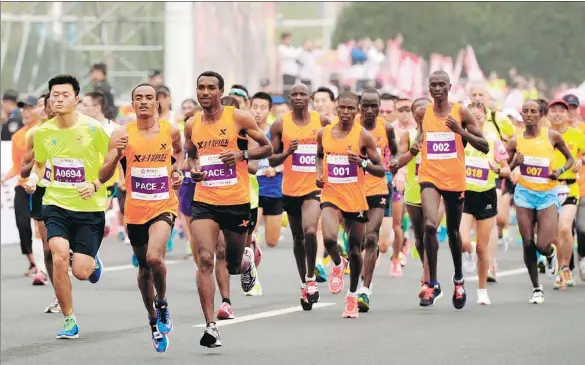  ?? AN XIN / FOR CHINA DAILY ?? African runners take part in the 2016 Nanjing Internatio­nal Marathon. The marathon boom in China has become a launch pad for thousands of athletes from the continent.