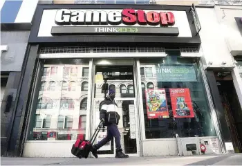  ?? — Reuters ?? A person walks past a Gamestop store in the Manhattan borough of New York City, New York.