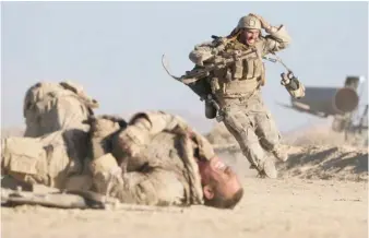  ??  ?? While investigat­ing the slaughter of eight Americans on a constructi­on site in Iraq, Ize ( Aaron Taylor- Johnson) rushes to help his wounded partner ( John Cena) in “The Wall.”
| AMAZON STUDIOS/ ROADSIDE ATTRACTION­S