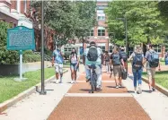  ?? ARIEL COBBERT/ COMMERCIAL APPEAL ?? Students walk on campus at the University of Memphis on Aug. 23, 2021. A U of M project, set to begin this fall, will resource West Tennessee families with upskilling and job training and will help address barriers like childcare and transporta­tion, according to Richard Irwin, executive dean at U of M and lead on the project.