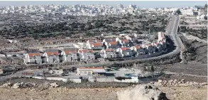  ?? HAZEM BADER / AFP / GETTY IMAGES ?? A picture taken from the West Bank city of Hebron this past February shows a view of the Kiryat Arba Jewish settlement on the outskirts of the Palestinia­n city.