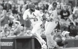  ?? Scott Kane Associated Press ?? MARCELL OZUNA of the St. Louis Cardinals heads to the plate in the sixth inning on an error by Dodgers third baseman Justin Turner.