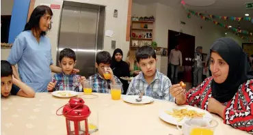  ?? Photo by Juidin Bernarrd ?? Parents, volunteers and specially-abled children enjoy a hearty Iftar at Senses Residentia­l and Day Care for Special Needs in Dubai on Wednesday. The centre is home to over 127 students with a variety of disabiliti­es. —