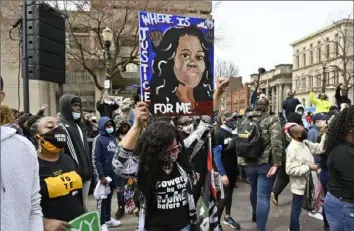  ?? Timothy D. Easley/Associated Press ?? A protester holds up a painting of Breonna Taylor during a rally March 13 on the one-year anniversar­y of her death at Jefferson Square Park in Louisville, Ky. Hundreds of potential jurors who gathered at a Louisville courthouse on Friday will learn whether they could be chosen for the only criminal trial over the botched police raid that left Taylor dead.