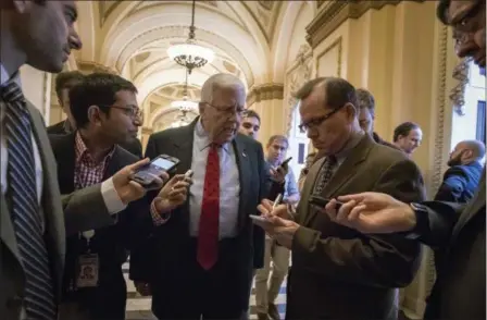  ?? J. SCOTT APPLEWHITE — THE ASSOCIATED PRESS ?? Reporters interview Sen. Mike Enzi, R-Wyo., chairman of the Senate Budget Committee, as arrives Dec. 15 to meet with House Ways and Means Committee Chairman Kevin Brady, R-Texas, at the Capitol to advance the GOP tax bill, in Washington.