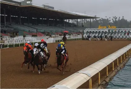  ??  ?? Horses run in the fourth race at Santa Anita Park in front of empty stands, Saturday, March 14, 2020, in Arcadia, Calif. While most of the sports world is idled by the coronaviru­s pandemic, horse racing runs on. (AP Photo/Mark J. Terrill)