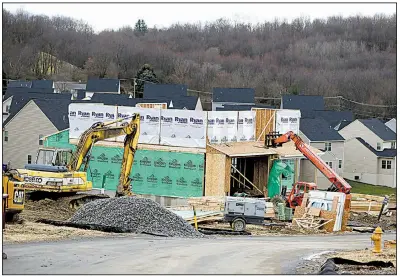  ?? AP file photo ?? Workers construct a home at a developmen­t in Zelienople, Pa., in the spring. Housing starts surged in November, with single-family homes being built at the fastest pace since 2007.