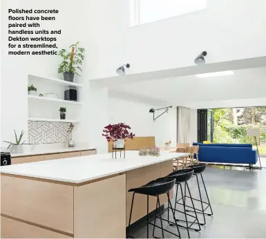  ??  ?? POLISHED CONCRETE FLOORS HAVE BEEN PAIRED WITH HANDLESS UNITS AND DEKTON WORKTOPS FOR A STREAMLINE­D, MODERN AESTHETIC
