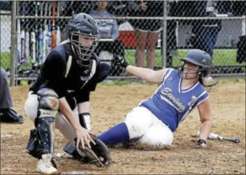  ?? JOHN BLAINE — FOR THE TRENTONIAN ?? Ewing’s Laura Christense­n (7) slides safely into home plate as Burlington Twp. catcher Megan Wiesnewski receives the throw during Tuesday’s playoff game.