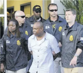  ?? ?? United States Drug Enforcemen­t Administra­tion agents take Christophe­r “Dudus” Coke from Westcheste­r County Airport to a waiting vehicle on Thursday, June 24, 2010, in White Plains, New York, after he was extradited from Jamaica.