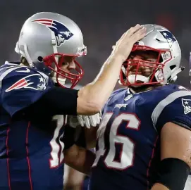  ?? NAncy lAnE / HErAld StAff filE ?? JOB WELL DONE: James Develin is congratula­ted by Tom Brady after scoring a touchdown on Dec. 2, 2018 in Foxboro.