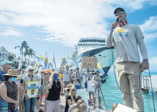  ?? MARK HEDDEN For the Miami Herald ?? Key West fisherman Will Benson speaks to a crowd of protesters on Feb. 5 as a large ship arrives in Key West.