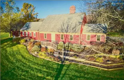  ?? Photos by Jesse Walsh and Yen Wang ?? The Shaker farmhouse reproducti­on sits on 21 acres. At left is the living room.