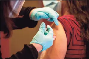  ?? Getty Images ?? Dr. Diana Rodriguez receives the COVID-19 vaccine with the first batch of Moderna’s vaccine at Hartford Hospital on Dec. 21.