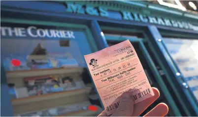  ?? Picture: Kris Miller. ?? A ticket holder outside M&S Richardson newsagents in Forfar after rumours that a £10 million winning Lotto ticket was purchased from the shop started circulatin­g the town.